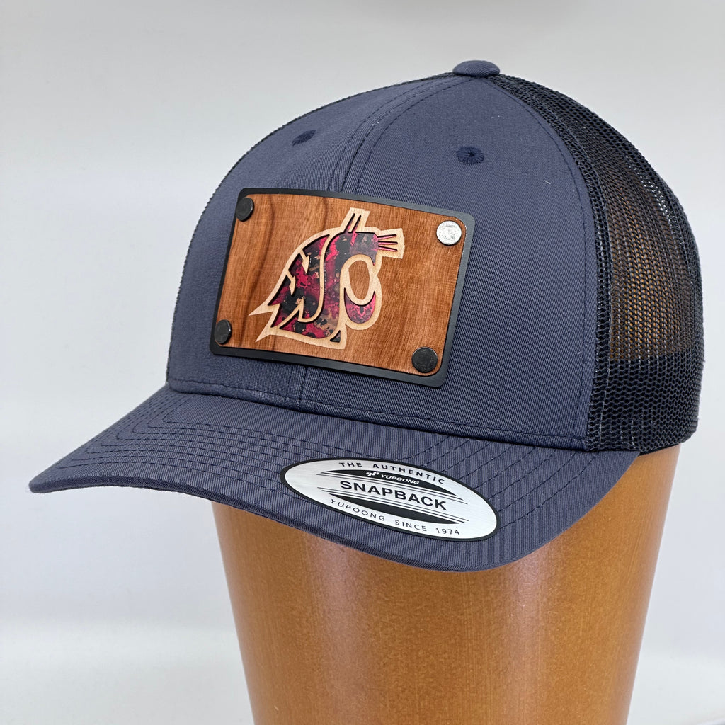 A custom Grey hat featuring an etched cherry wood veneer and red coper inlay patch.
