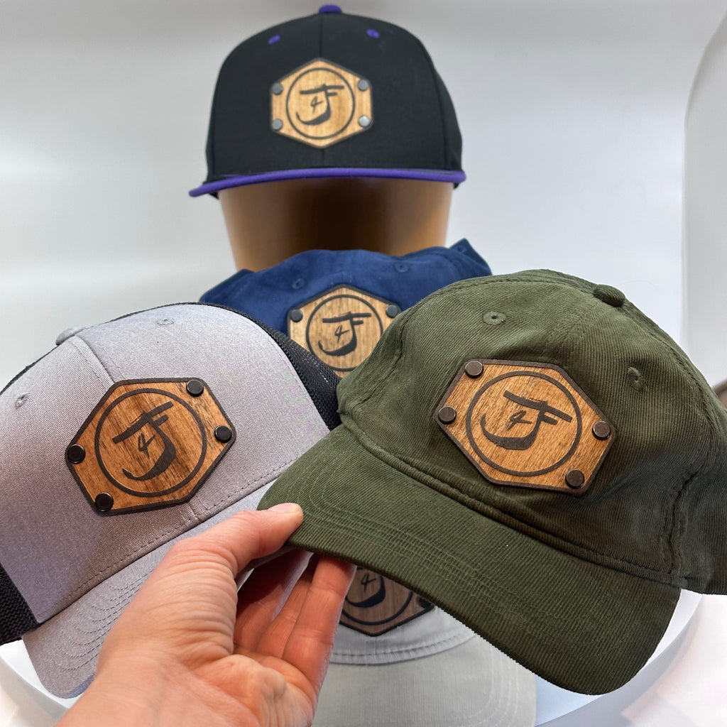 Custom wood patch hats featuring the logo of Just 4 Frilz