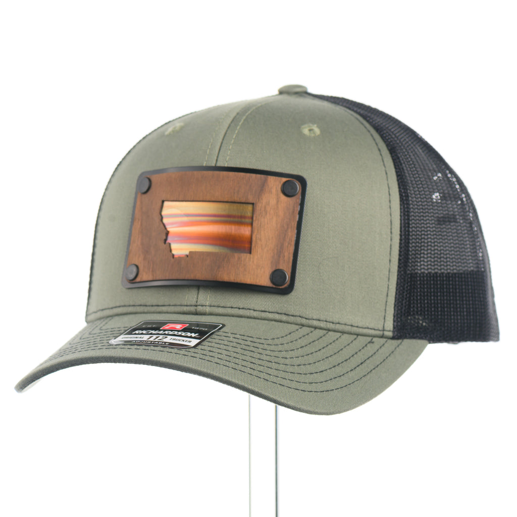 Green trucker cap with a walnut wood Montana and Copper patch and black mesh back on a white background