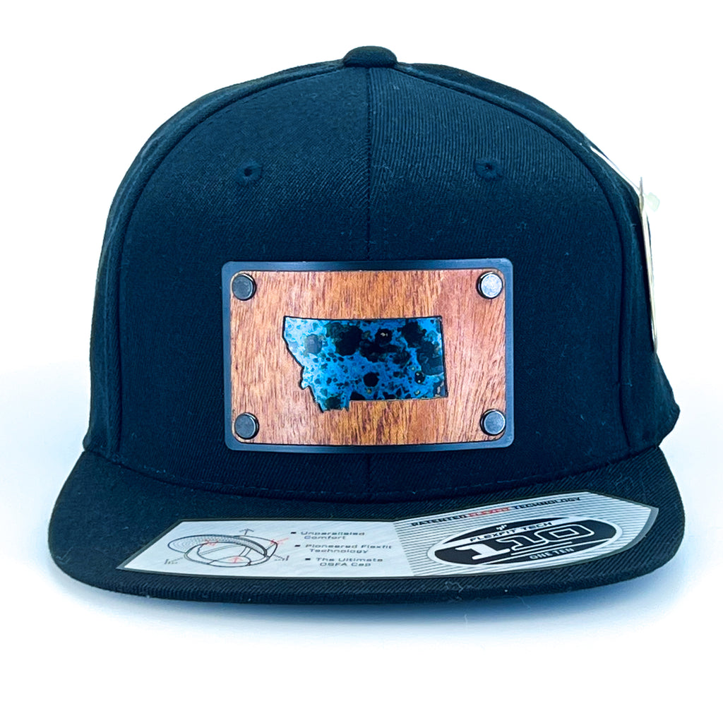 A Montana state mahogany wood and copper veneer plate patch riveted to a black Flexfit flat bill hat.