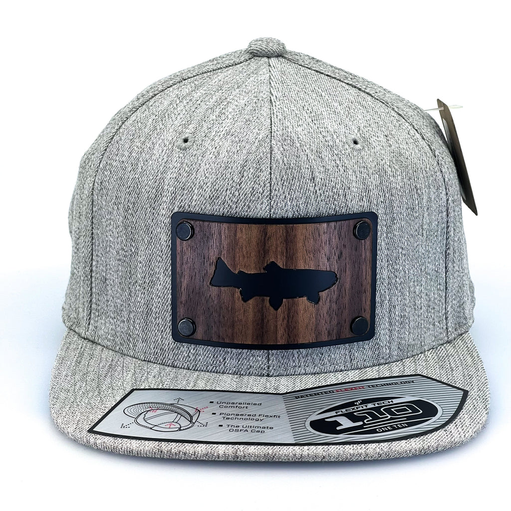 A Heather Gray flex fit flat bill featuring a trout silhouetted walnut wood plate patch.